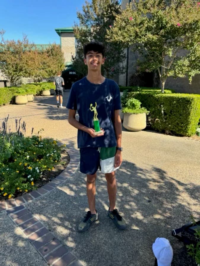 Arjan holding a tennis trophy