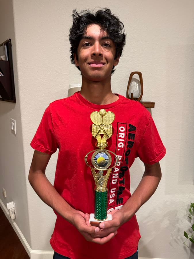 Arjan holding a tennis trophy